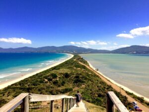 The Neck Lookout on Bruny Island offers breathtaking views of the isthmus connecting North and South Bruny, with turquoise waters on either side.