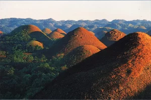 These unique geological formations consist of over 1,200 cone-shaped hills that turn chocolate brown during the dry season, creating a stunning natural landscape.
