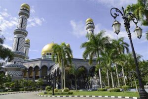 A grand mosque with intricate Islamic architecture and beautiful gardens.