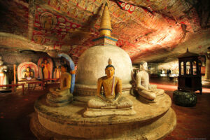 A complex of cave temples adorned with intricate Buddhist murals and statues.